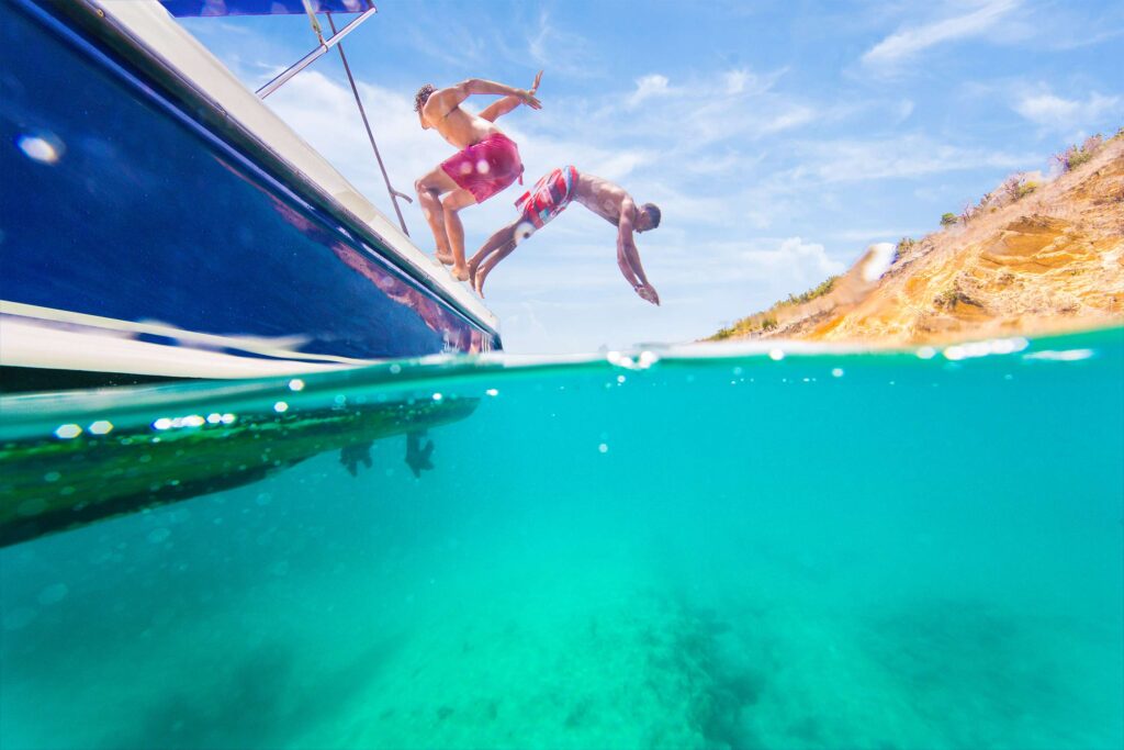 Travellers diving in crystal clear waters
