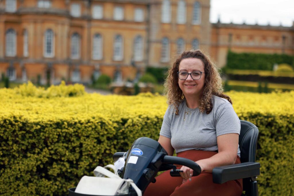 Disabled traveller Carrie-Ann Lightley poses for a picture in front of a Manor House