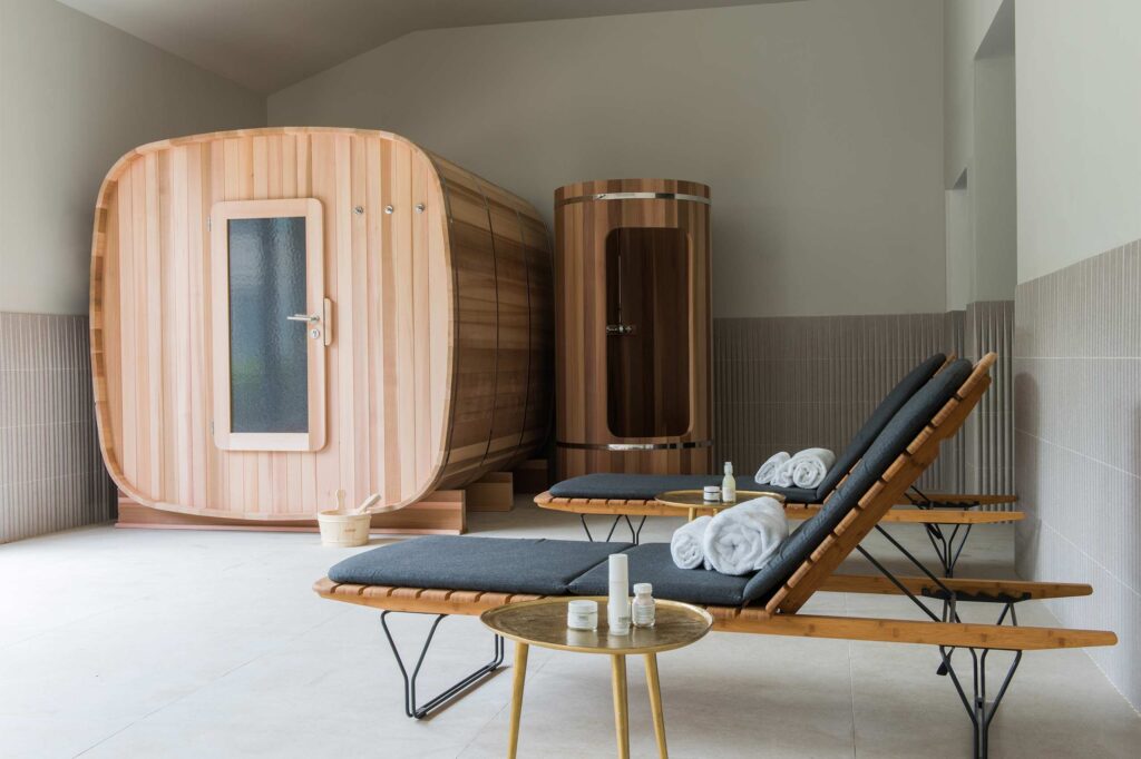 Wooden sauna booths with loungers beside them at Domaine de Primard Guainville - Chic stays outside of Paris.