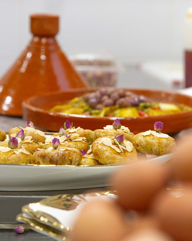 A tray with small cakes topped with rosebuds at the Amal Center in Marrakech. A cooking class here belongs on any Experiential gift guide
