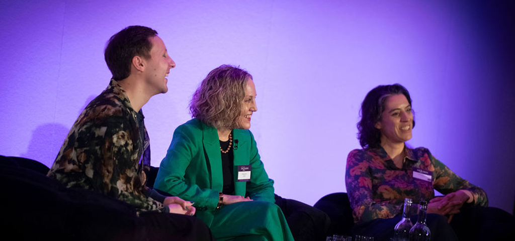 Panelists share a joke on stage at Icons of Inclusion 2024