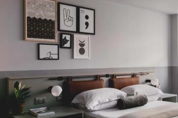 Bedroom interiors at Leven Manchester with monochrome artwork above bed and brown leather headboard