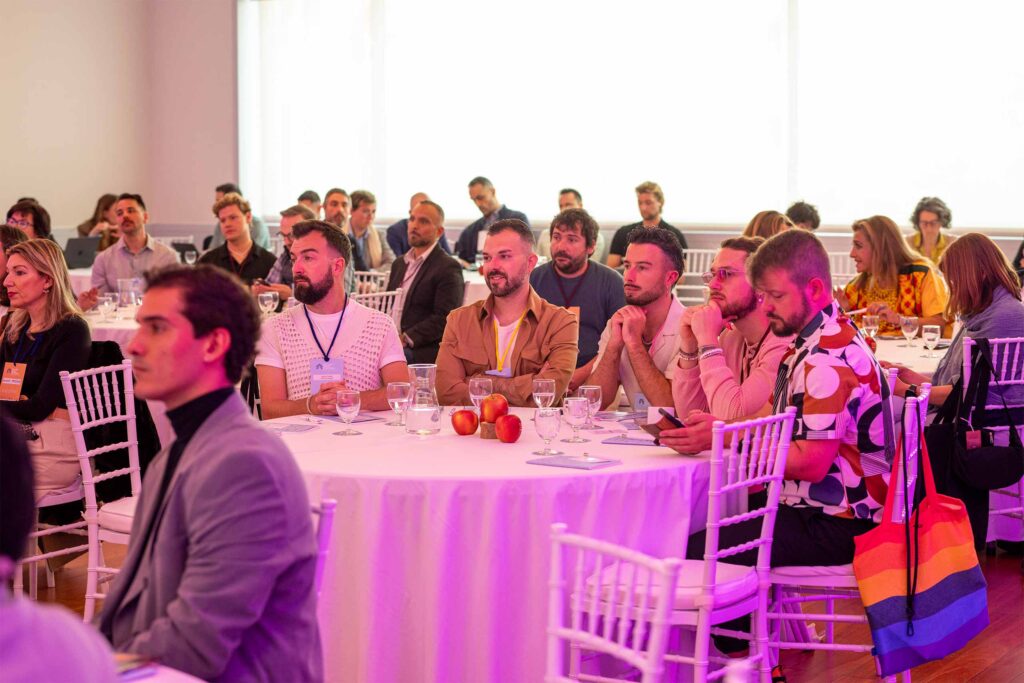 A crowd of travel professionals look towards the stage at the LGBT+ Travel Symposium.
