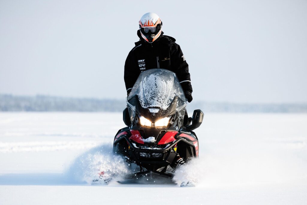 A guest riding a snow mobile in Finnish Lapland, Finland