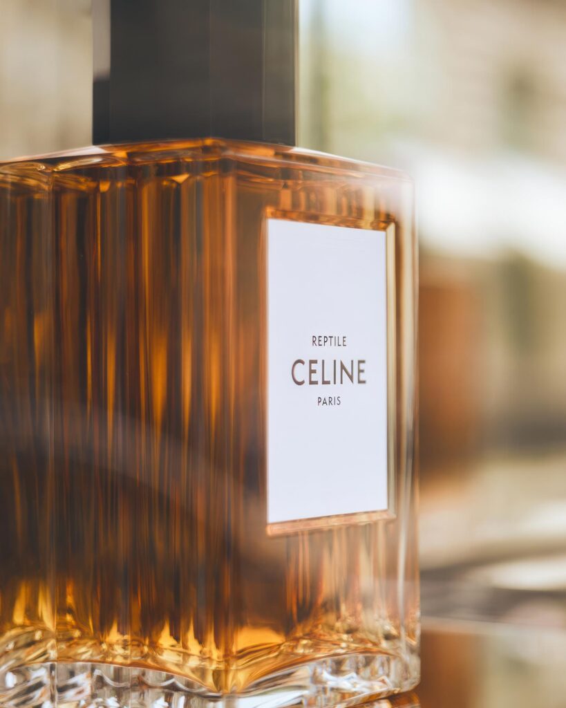 A bottle of Céline perfume in a shop window, one of many postcards from Paris, France
