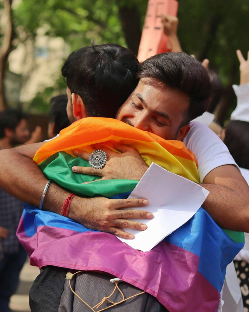 Two Pride attendees hugging