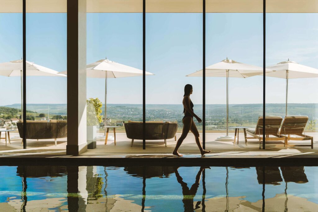 A guest walking beside the spa pool at the Royal Champagne Hotel & Spa.