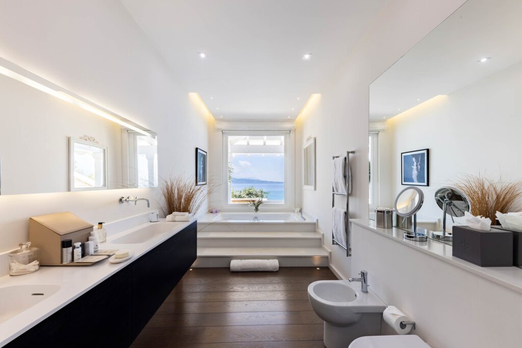 Ultima Collection x Burgess Yachts – bathroom at Ultima Corfu with window against the ocean